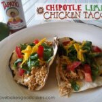 Chipotle Lime Chicken Tacos on plate with lime and Tapatio sauce.