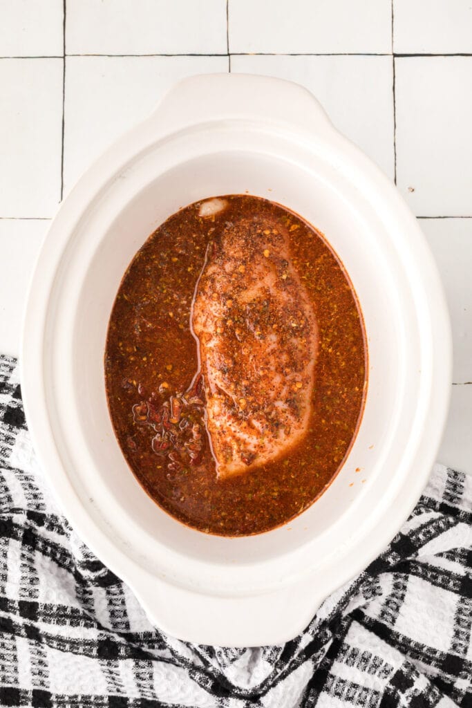 Chicken breasts covered with chipotle lime sauce in a slow cooker