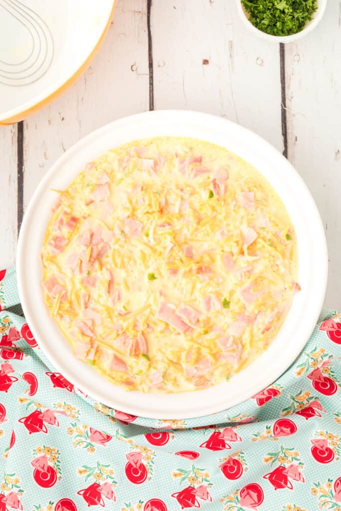 Baking dish filled with the uncooked ham and cheese mixture, ready to go into the oven.