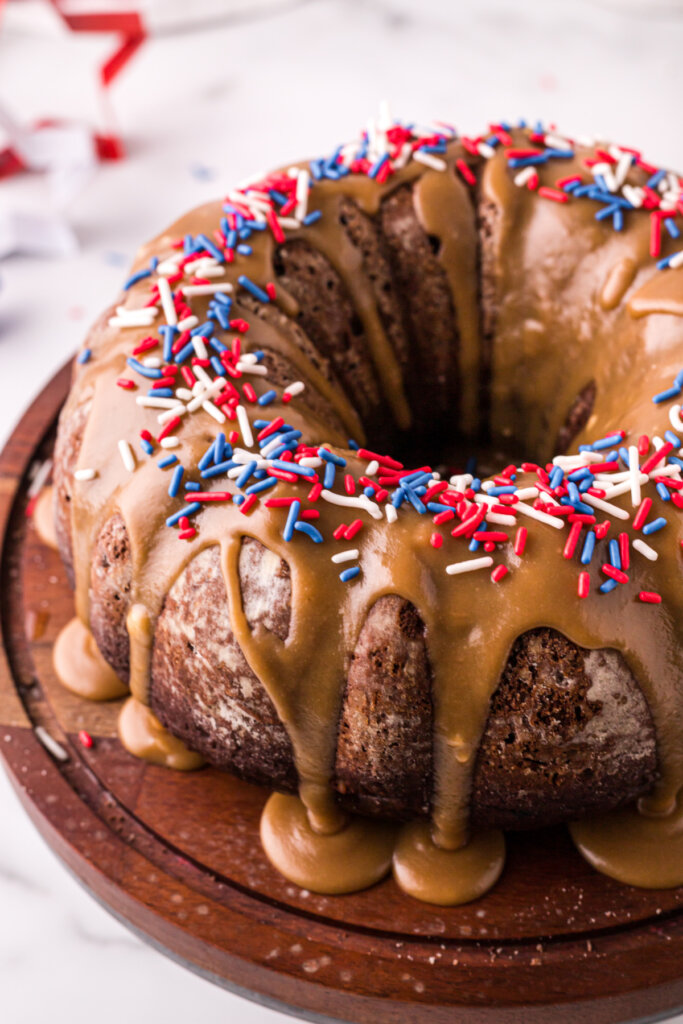 apple spice cake with caramel frosting decorated with red white and blue sprinkles