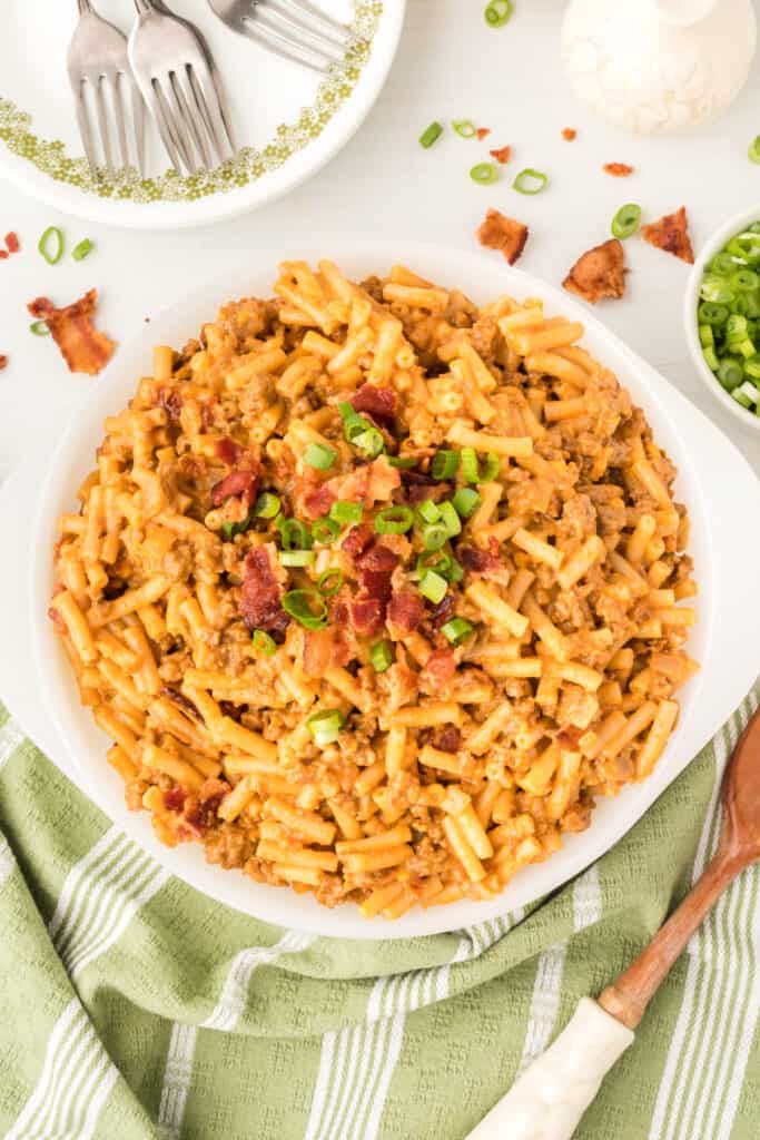 BBQ Beefy Mac and Cheese in a serving dish topped with bacon and green onions