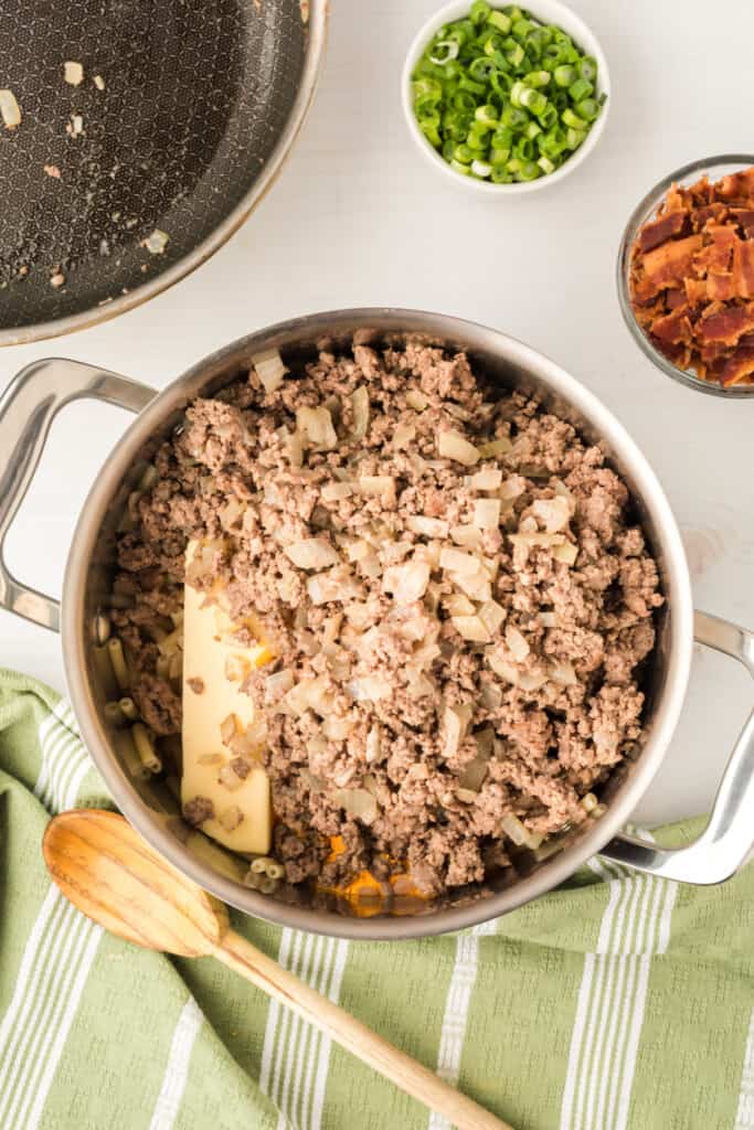 cooked ground beef added to macaroni and cheese mixture for BBQ Beefy Mac and Cheese