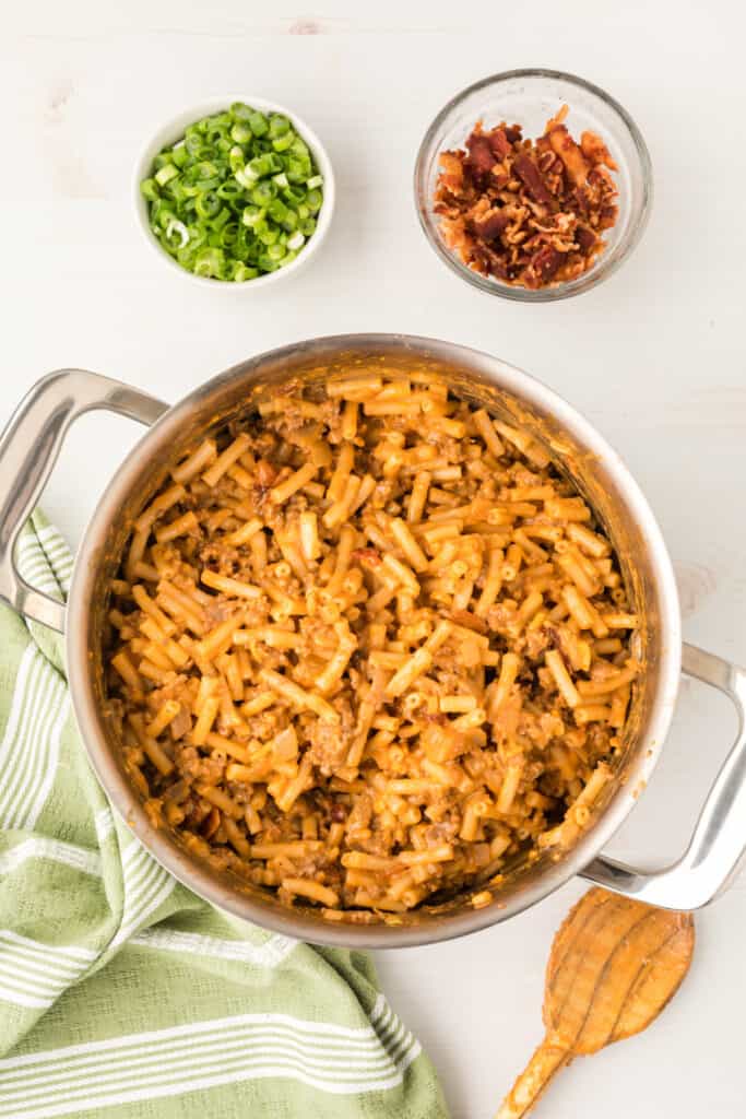 BBQ Beefy Mac and Cheese mixed together in a pot with bacon added