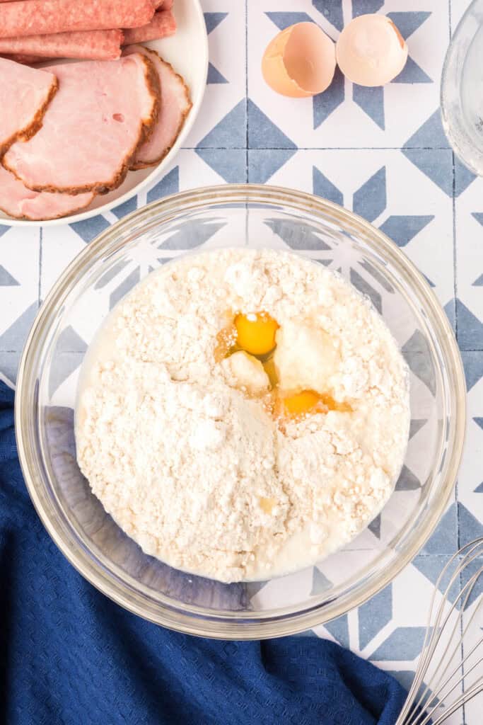 Pancake batter ingredients in glass mixing bowl for Breakfast Kabobs and Mini Pancakes