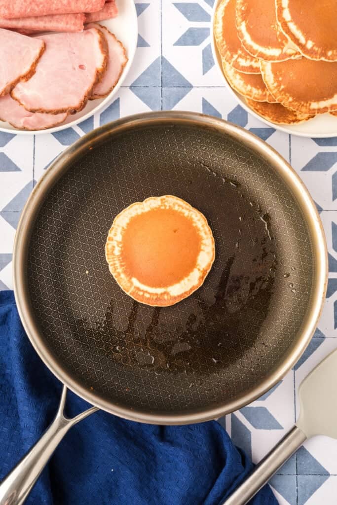 Golden mini pancakes cooking in skillet for Breakfast Kabobs and Mini Pancakes
