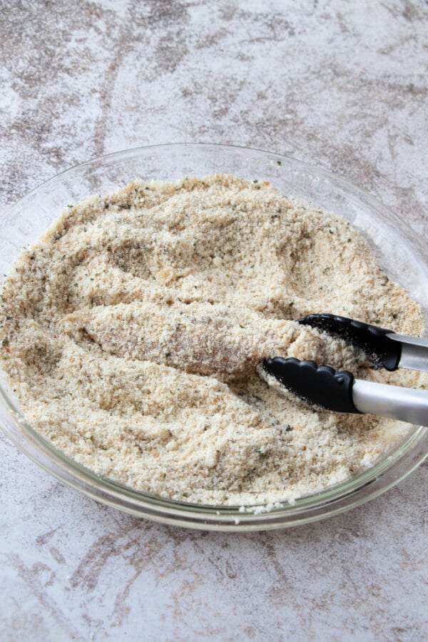 coating the chicken strips in breadcrumb and parmesan mixture