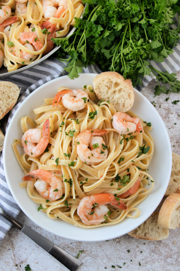 looking down into a bowl of finished shrimp scampi with pasta