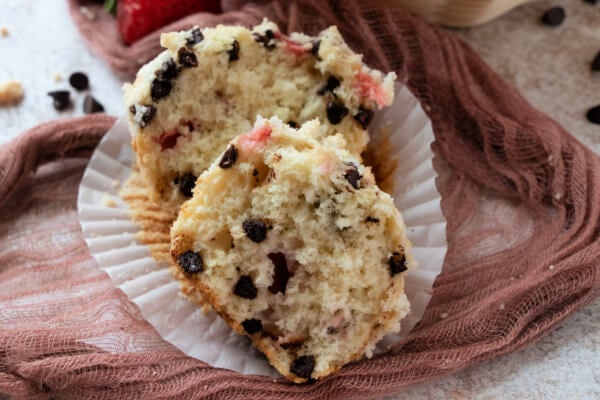 Chocolate chip muffin split in half to show inside.