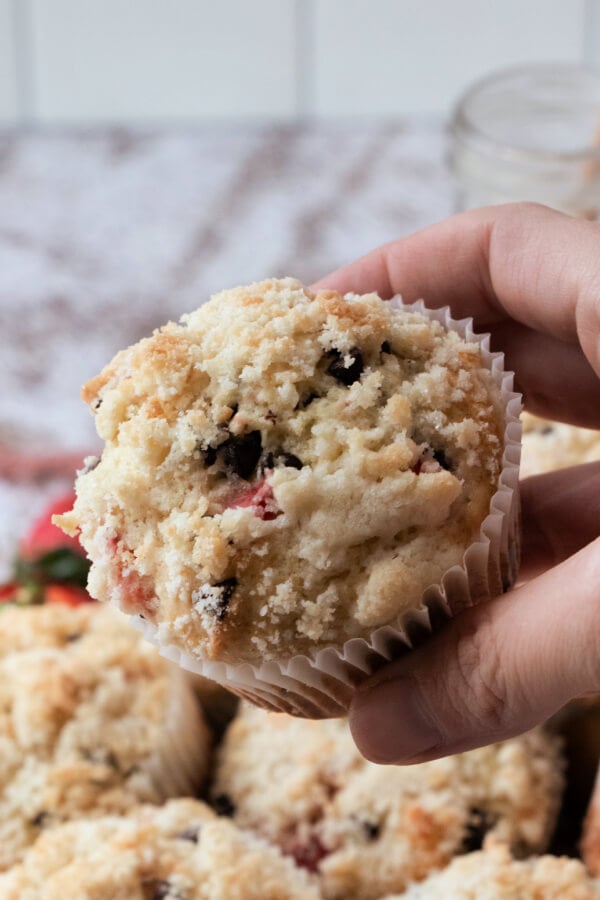 Someone holding a finished muffin.