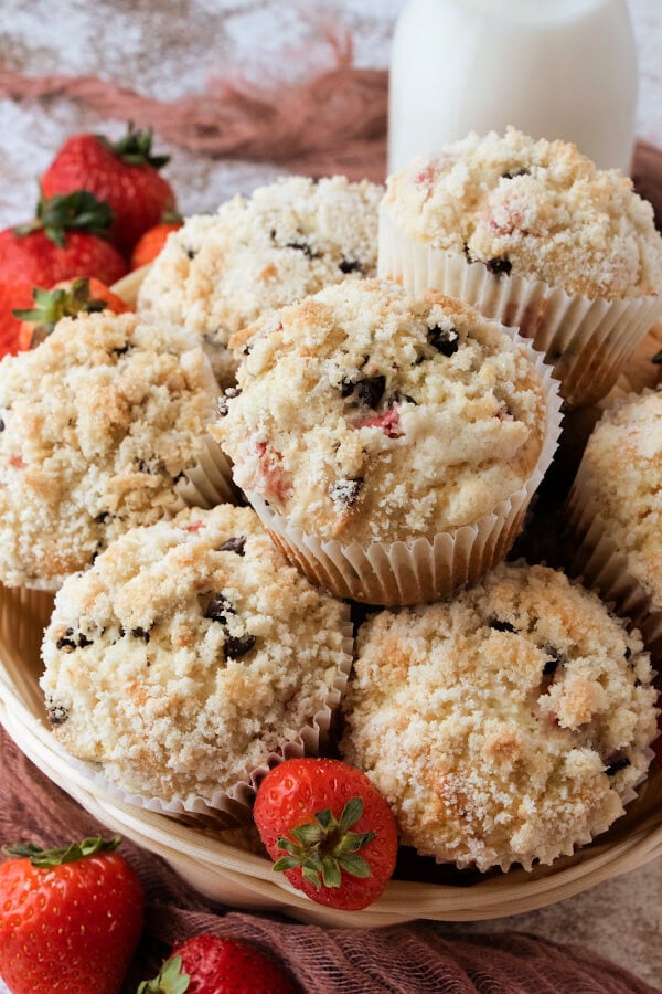 Strawberry chocolate chip muffins in basket with milk.