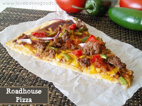 A slice of pizza on a place mat with red and green peppers nearby.