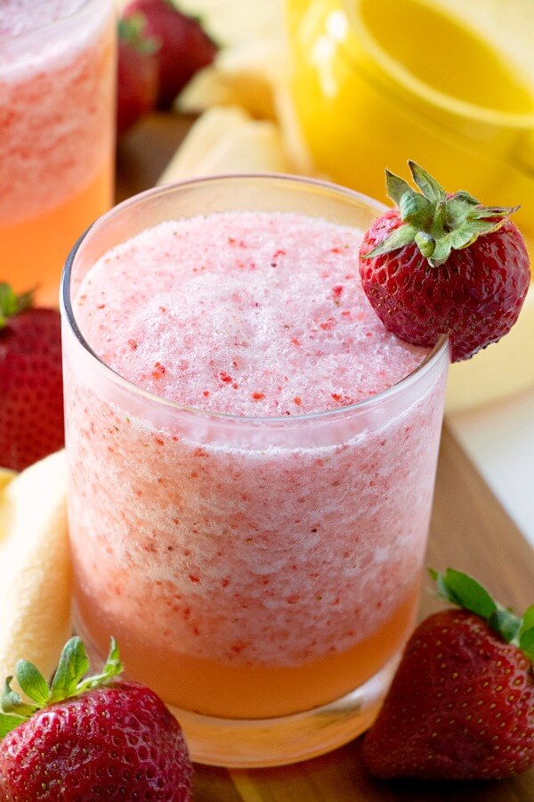 Lemon Berry Fruit Slush in glass with strawberry garnish