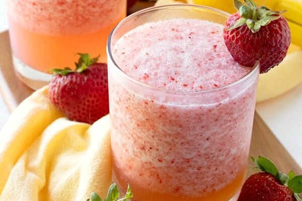 lemon berry fruit slush in glass with strawberry garnish
