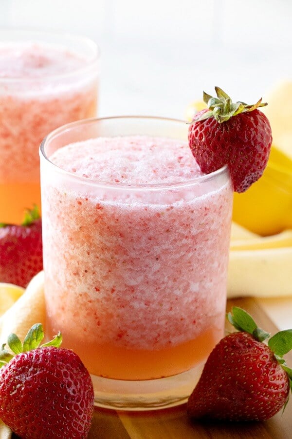 glass of lemon berry fruit slush garnished with a strawberry