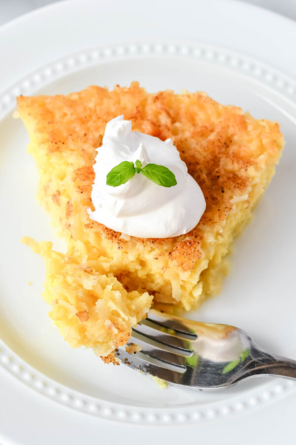 bite of pie on fork laying on plate with pie