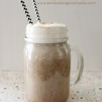 Pumpkin Spice Latte in glass with two straws.