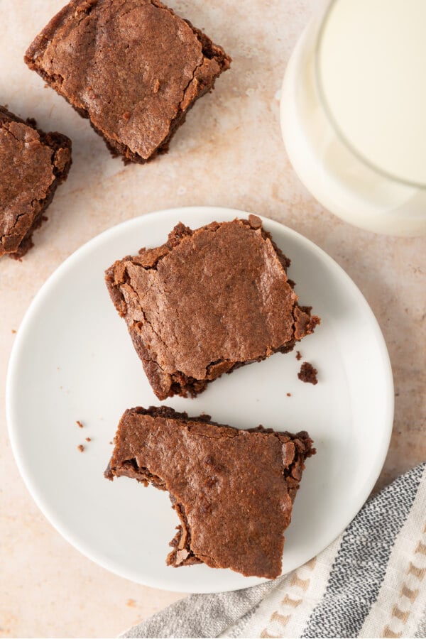 cut brownies on plate one with bite taken out