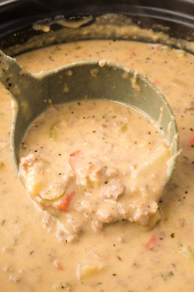 cheeseburger soup in pot with ladle