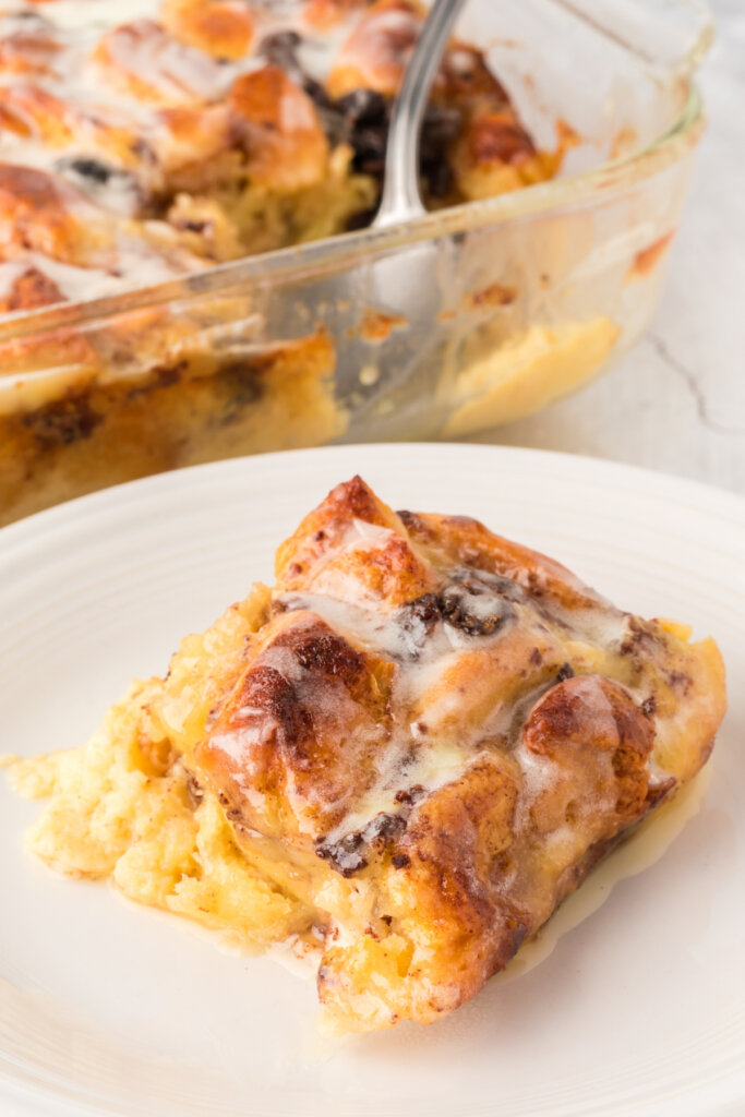 slice of cinnamon roll bread pudding on plate