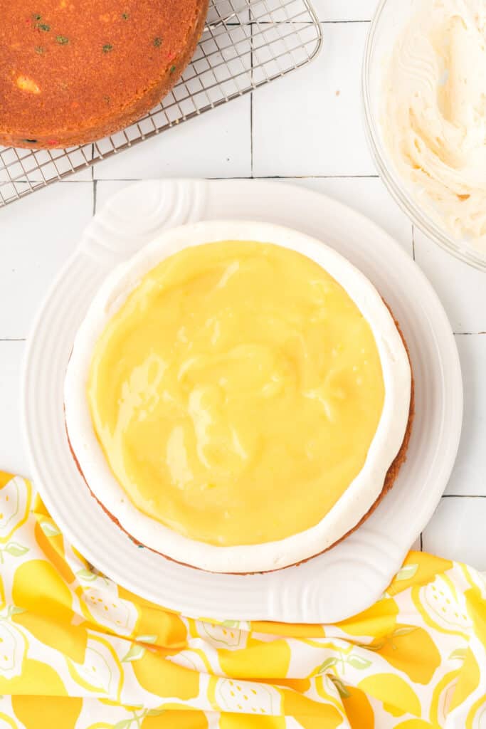 center of lemon funfetti cake with frosting and lemon curd