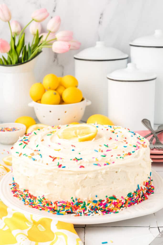 whole decorated lemon funfetti cake on plate