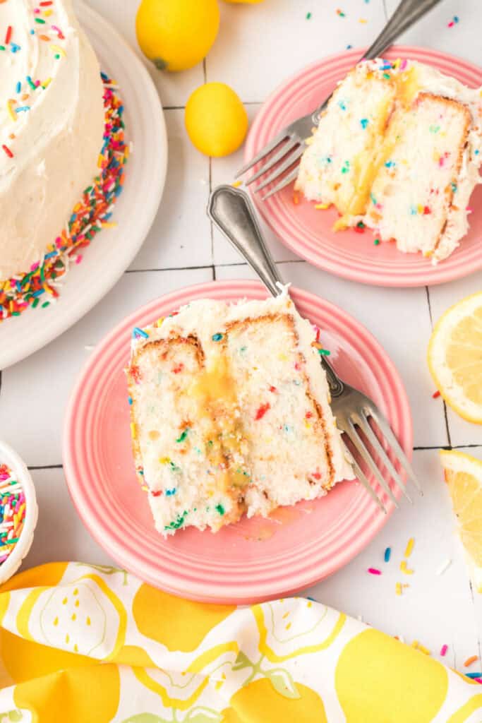 slice of lemon funfetti cake on pink plate