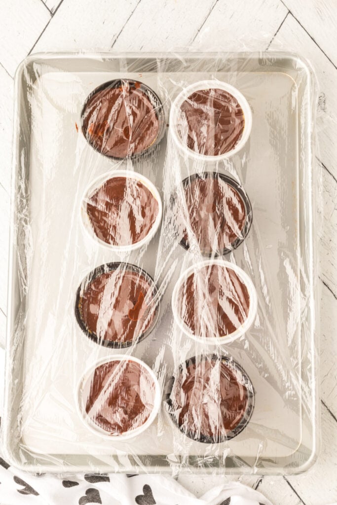 Cappuccino Crème Brûlée desserts covered with plastic wrap