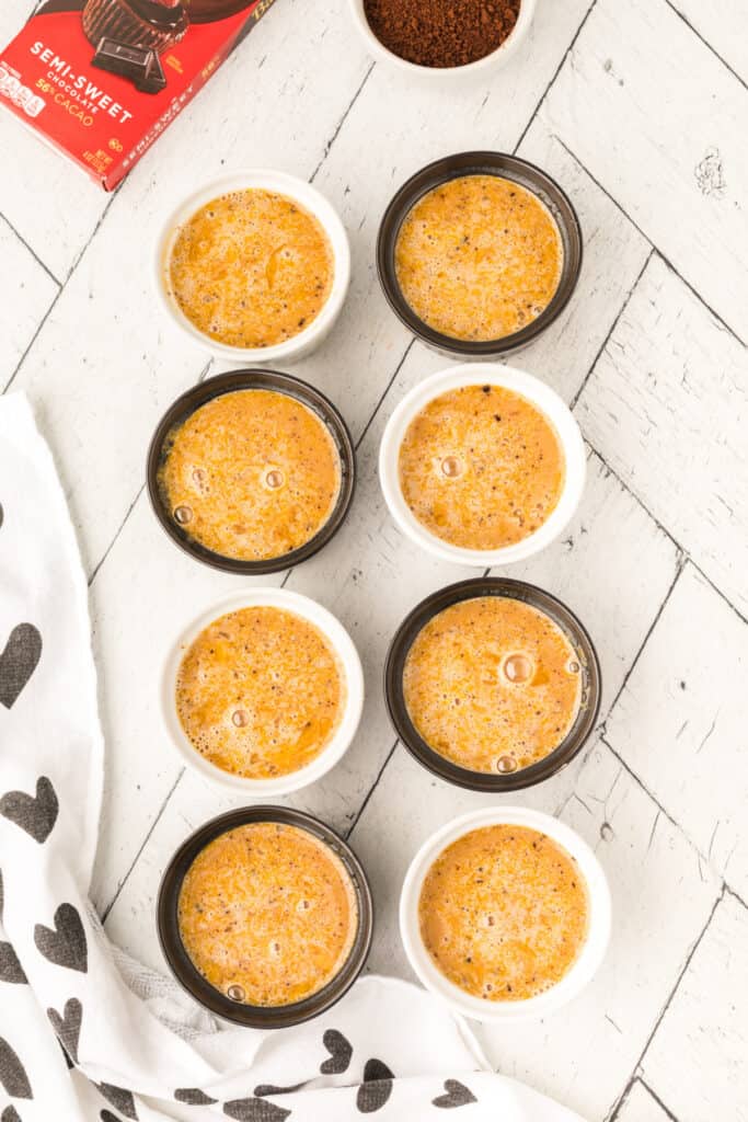 Cappuccino Crème Brûlée custard mixture poured into ramekins before baking