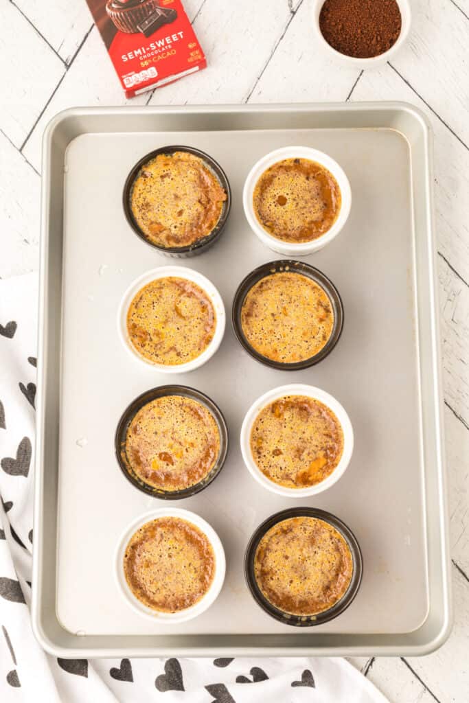 Baked Cappuccino Crème Brûlée custards cooling in ramekins on a baking sheet