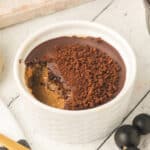 Square image of Cappuccino Crème Brûlée topped with chocolate and espresso garnish in a white ramekin