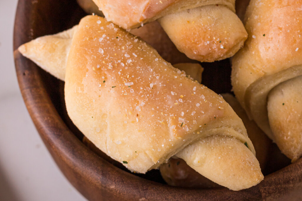 crescent roll in wooden bowl