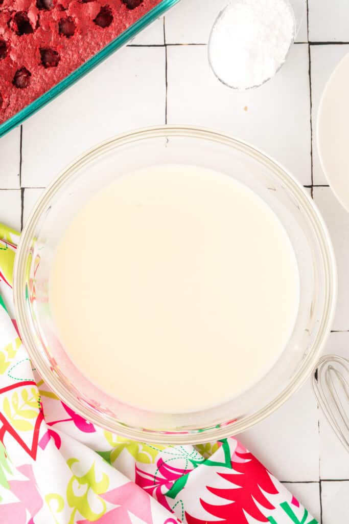 Smooth white chocolate pudding mixture in a glass bowl after whisking.