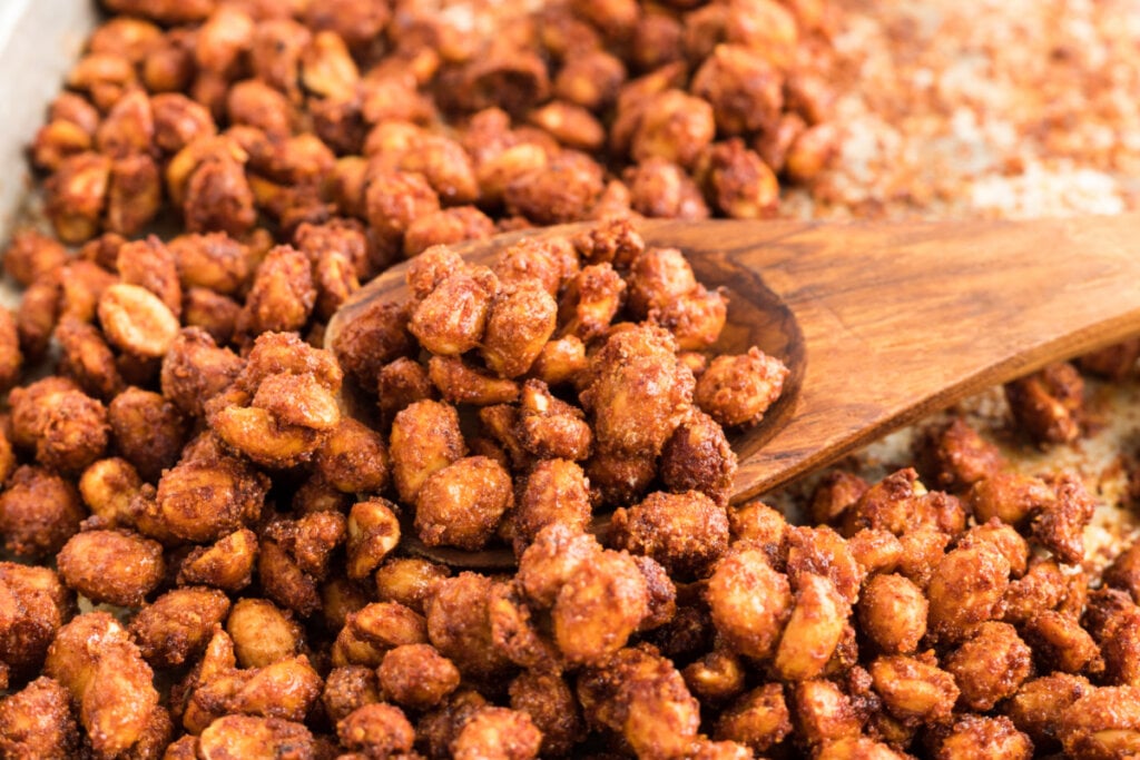 baking sheet with wooden spoon and barbecued peanuts