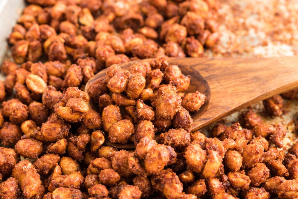 baking sheet with wooden spoon and barbecued peanuts