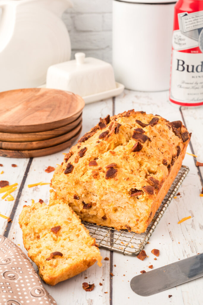 bacon cheddar beer bread with beer in background