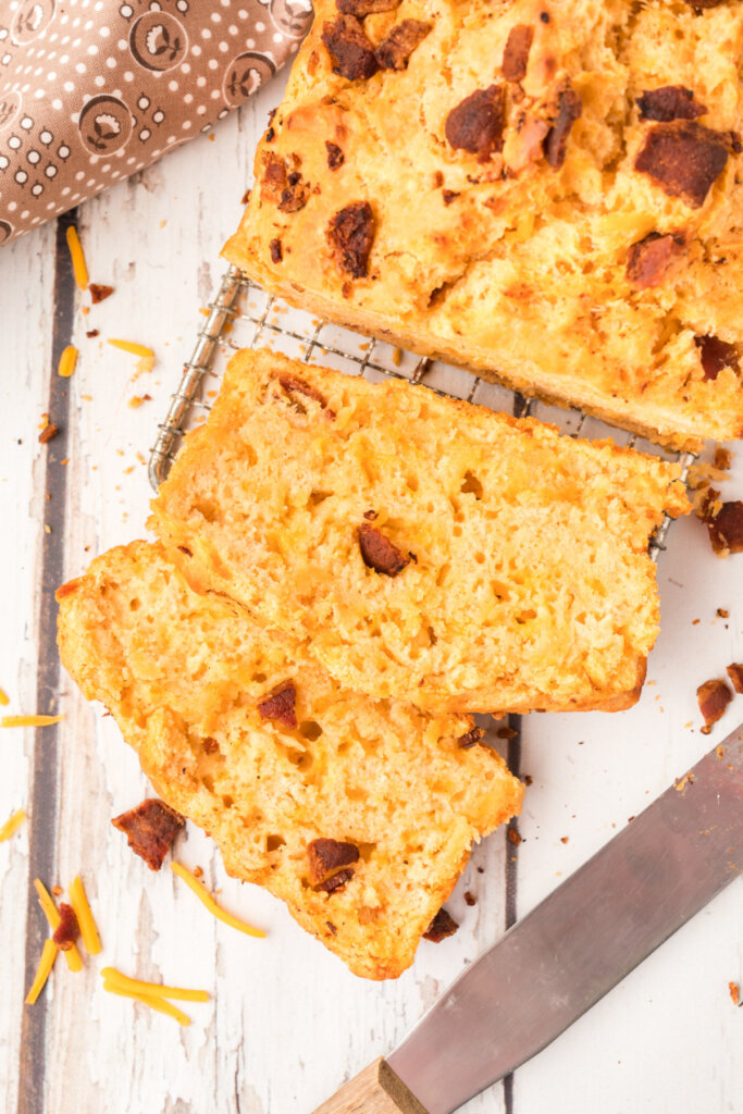 slices of bacon cheddar beer bread cut from loaf