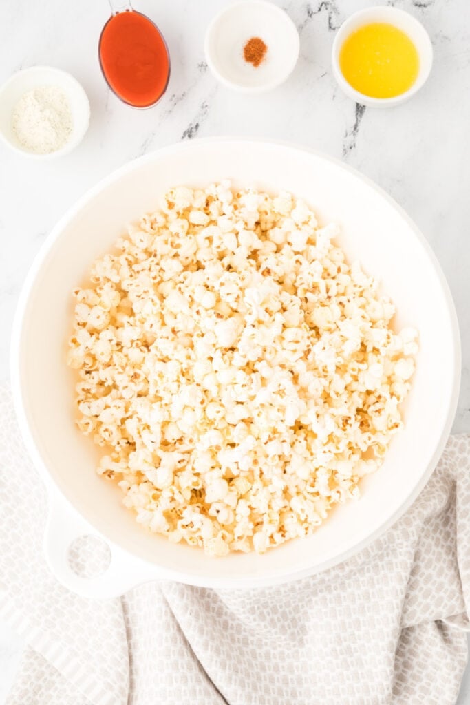 Air-popped popcorn in a large white bowl for Buffalo Ranch Popcorn recipe
