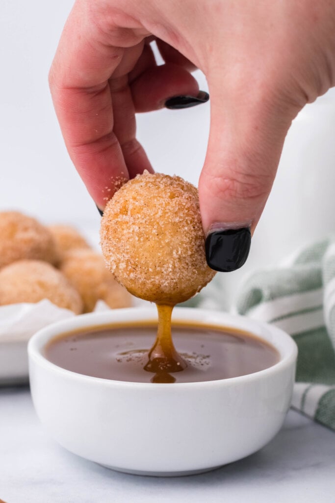 churros for a party being dipped into caramel sauce