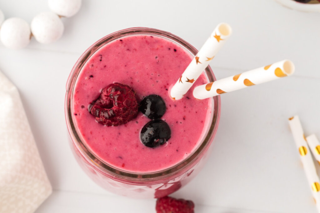 looking down into a glass with banana berry smoothie