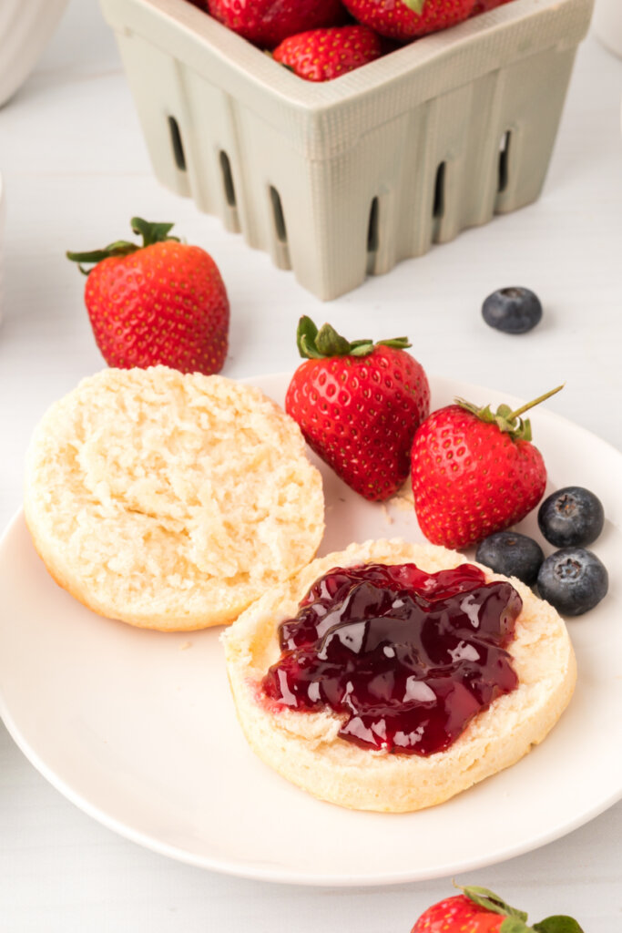 BEST Homemade Buttermilk Biscuits on plate split open with jelly