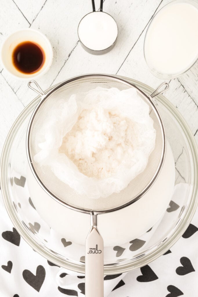 Line a strainer with a few layers of cheesecloth and place it over a large bowl. Pour the rice water through. Squeeze as much of the liquid out as you can. Discard the rice.