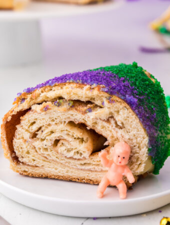 slice of king cake with baby on plate