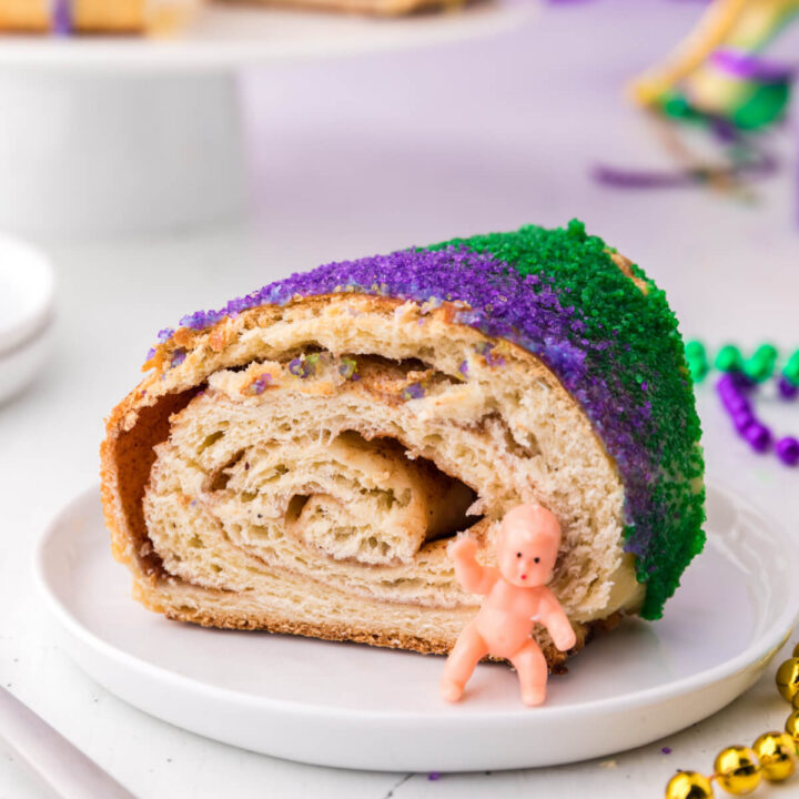 slice of king cake with baby on plate