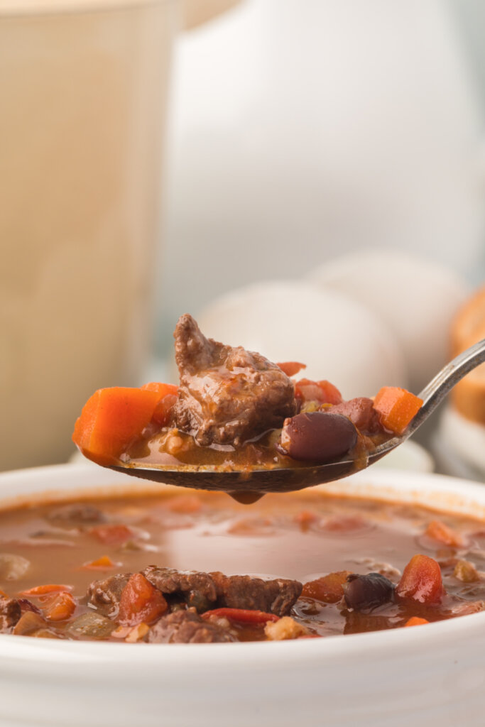 spoon with beef bean and barley soup