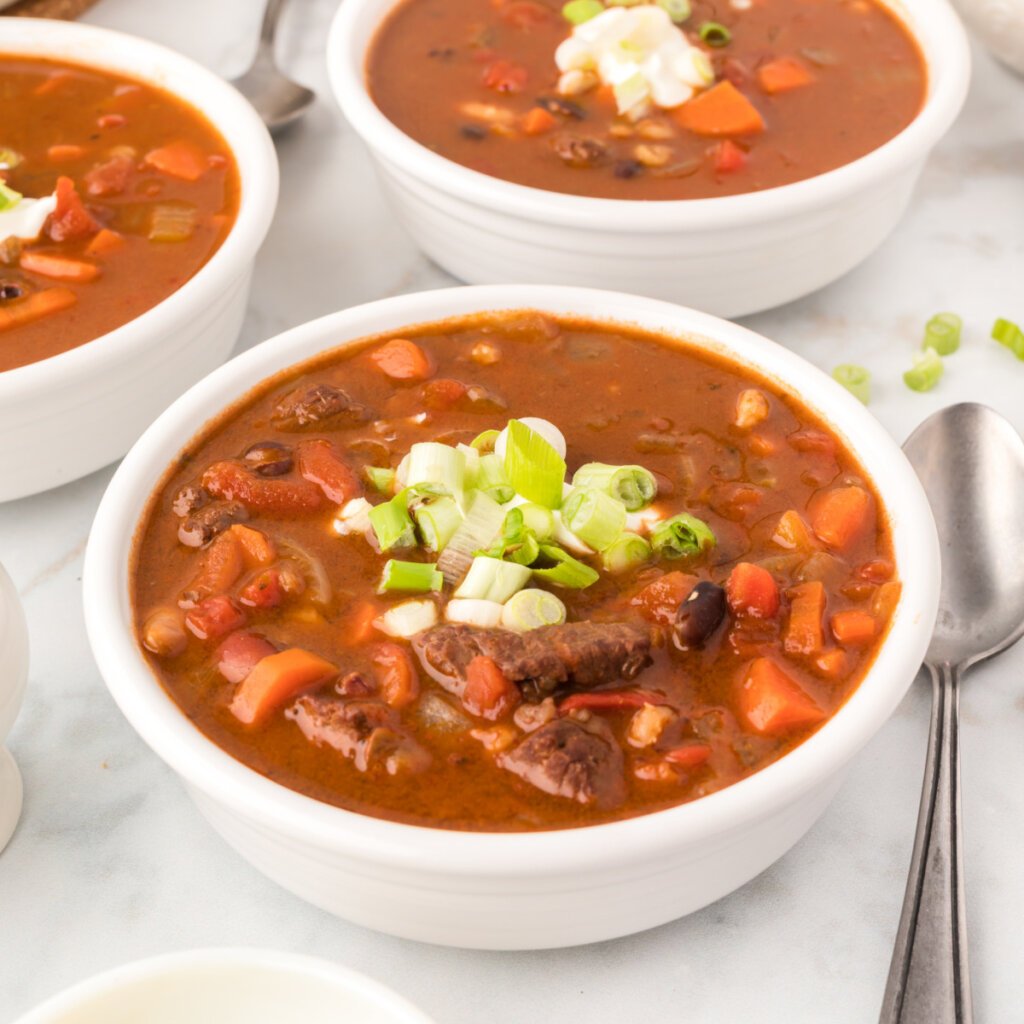southwest beaaf bean and barley soup in a white bowl