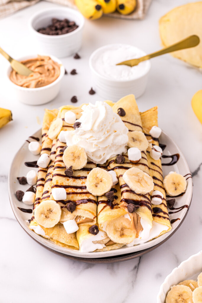 banana fluffernutter crepes topped with bananas chocolate syrup and whipped topping
