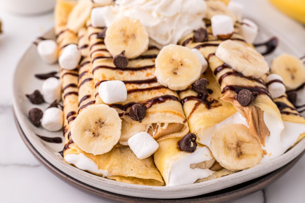 two banana fluffernutter crepes on plate