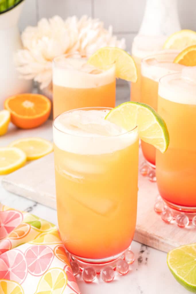Homemade Cactus Cooler mocktail served over ice with lime garnish and layered citrus colors