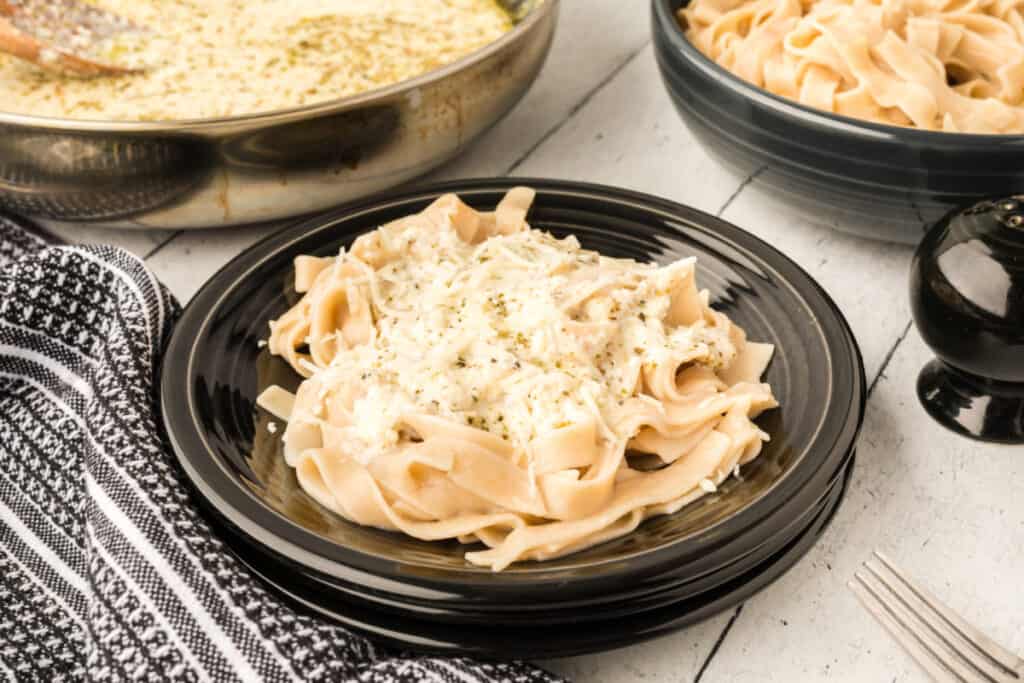 pasta with better for you alfredo sauce on black plate