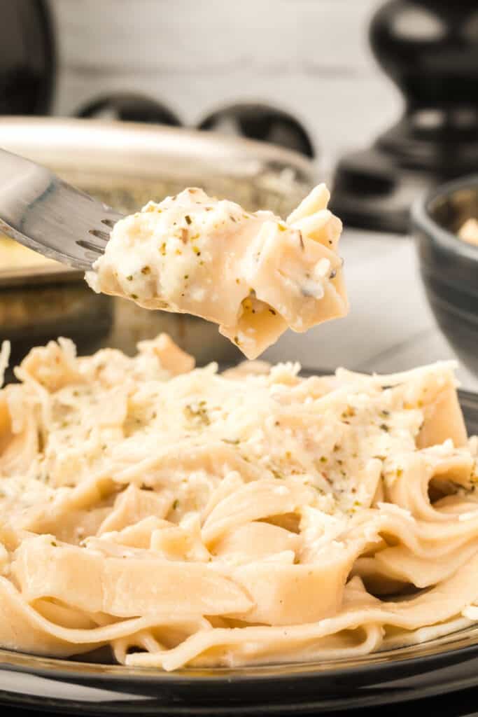 creamy pasta twirled on fork